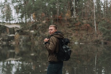 Portrait of Young Man with Backpack by Forest Lake