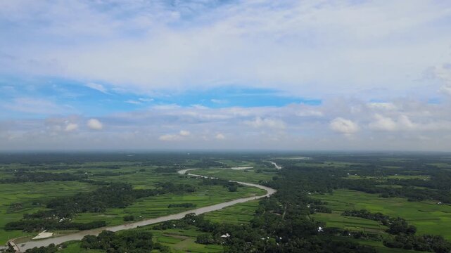 Aerial View of Winding River Through Green Agricultural Fields in Rural Bangladesh