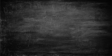A blank vintage blackboard with a dark grunge texture and a scratched aged surface provides a black chalkboard background for an old concrete wall design backdrop © PAGLAA
