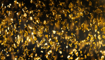 Gold backdrop of luxury transparent cream gel with sparkling 24k gold floating particles serum,...