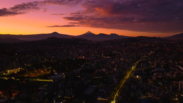 Quito, Ecuador at sunrise, with Cotopaxi volcano in the background.
