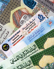 Oman resident card and driving license among Oman rial money bills on table close up. Permanent resident ID and drivers permit with Oman banknotes