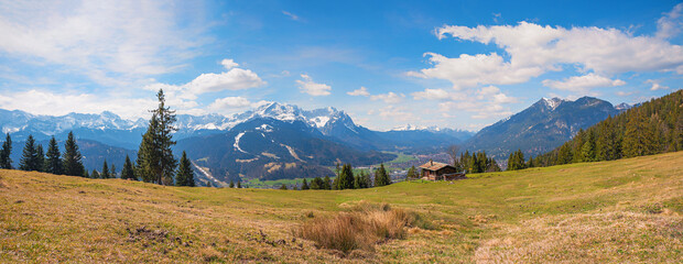 slope with hut and stunning view to Wetterstein alps, landscape bavaria near Garmisch