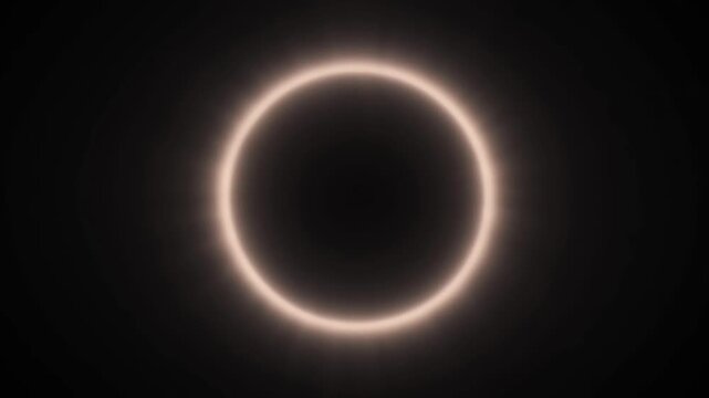 A glowing ring illuminated in the dark, viewed from a straight-on perspective, representing a celestial event or abstract concept