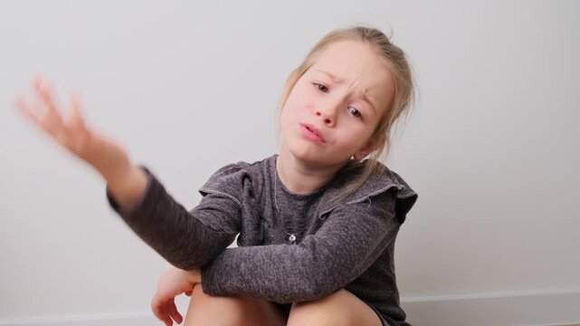 Young Girl Displays a Range of Negative Emotions against a Clean Background in a Series of Expressive Gestures