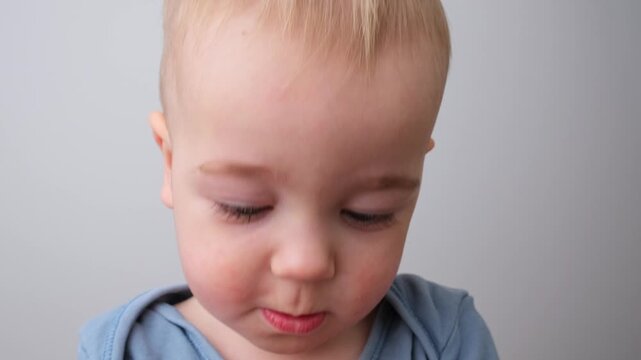 Cute Two-Year-Old Boy Plays with a Teether, Expressing Curiosity and Childlike Joy in a Bright Indoor Setting