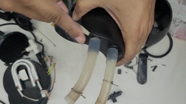 Broken electric coffee maker being disassembled