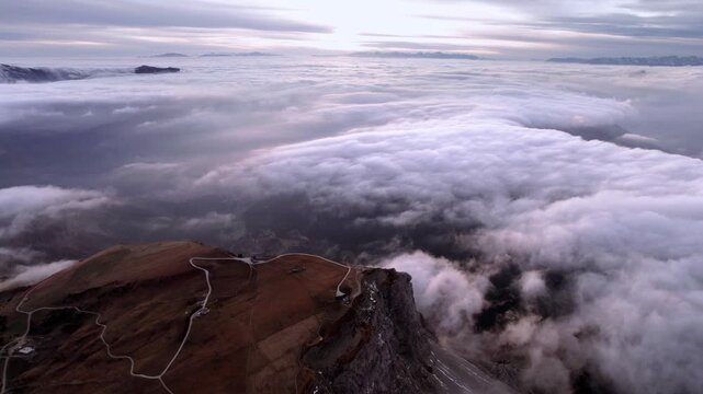 Vast sea of clouds floats below the summit of Seceda mountain in the italian Dolomites