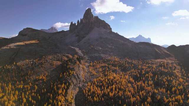 Croda da Lago peak in Dolomites, Italy. Golden larch forest valley underneath the mountain