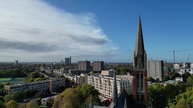 Aerial view of South Kilburn, Brent, highlighting the landmark St Augustines Church spire amidst ongoing estate regeneration.