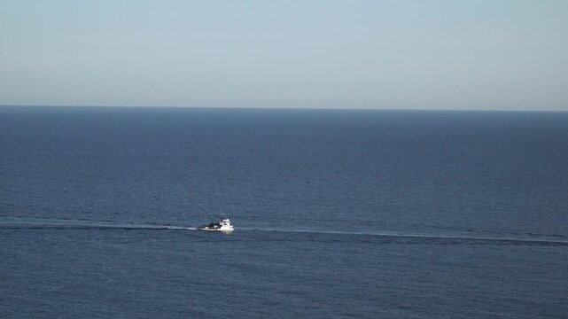 Small boat sailing in the sea. Rule of thrids composition