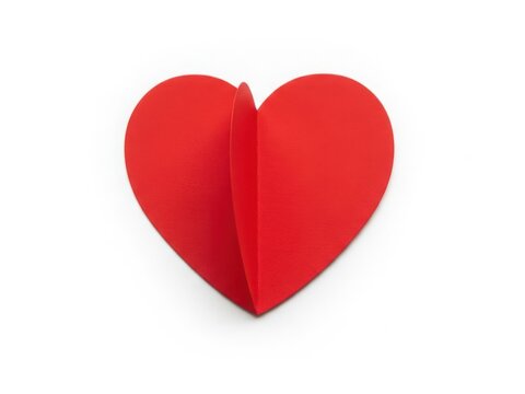 A vibrant red origami heart symbolizing love and affection crafted from paper.