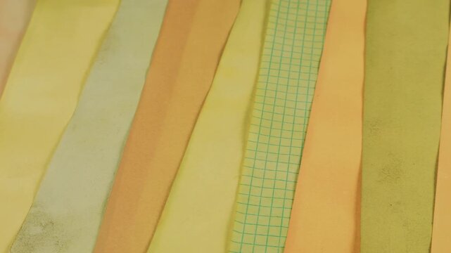 Natural dyed recycled paper texture background. Textured background of handmade paper strips. Eco-friendly, naturally dyed paper craft material. Abstract, colorful background perfect for scrapbooking.