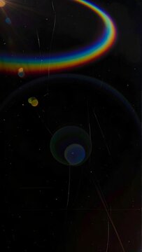 Dark, textured image with rainbow, circles, and light leaks