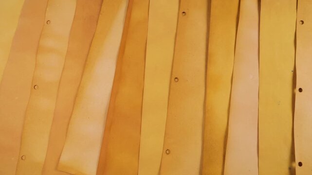A warm, inviting background of handmade paper in various shades of yellow, orange, and brown. The natural, eco-friendly texture suggests craft, recycling, and a junk journal aesthetic. 