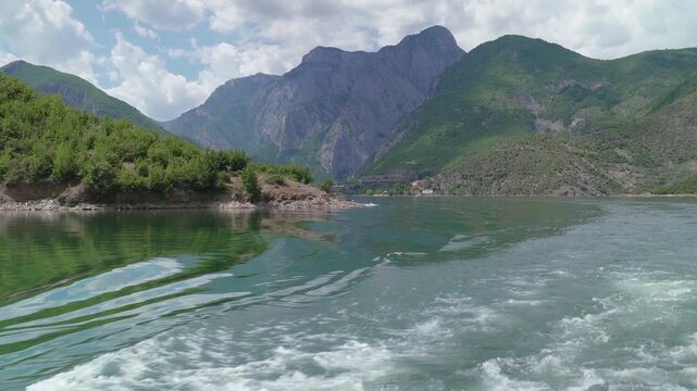 Ship sailing in river canyon of Koman reservoir in Albania