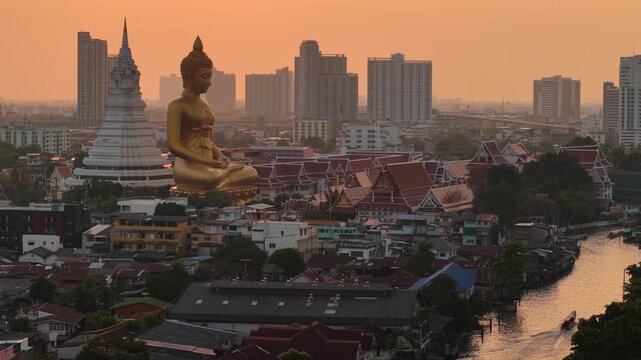 Aerial view Wat Paknam Bhasicharoen with wooden boat on river located in Phasi Charoen district, Bangkok, at the Chao Phraya River. It is part of the Maha Nikaya fraternity and is the origin of the Dh