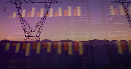 Framing steel lattice tower left of center in valley at dusk, carrying power lines, reflecting bars