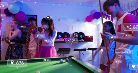 Playing seven friends in party clothes leaning over pool table at lounge, with cue and overlays