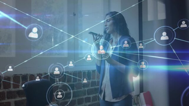 Woman speaking into phone tapping screen in office causing holographic tech network to map clients