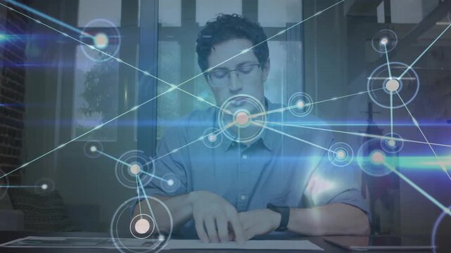 Seated man opening docs and activating HD overlay with nodes over desk, aiding business review
