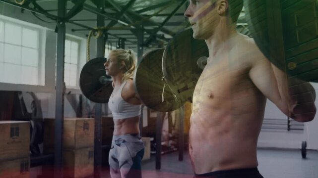 Partners starting from racked barbells, doing back squats for fitness, lens flare tracking motion