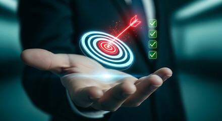 Businessman hand holding glowing target with arrow for success
