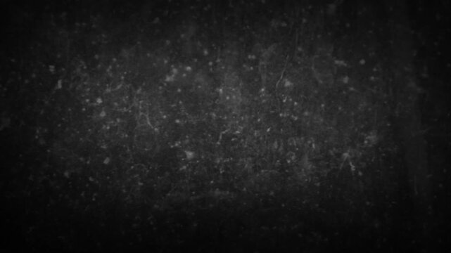 Slow moving monochrome grunge background with dirty black and gray texture and dark vignette edges, abstract backdrop for cinematic motion design.