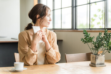 A woman reading a book while drinking coffee in a cafe