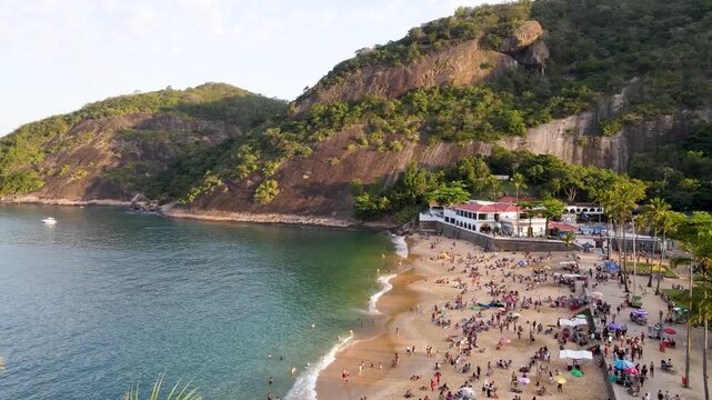 Drone Footage of Praia Vermelha Beach with people and Morro da Urca Coastline, Rio de Janeiro, Brazil