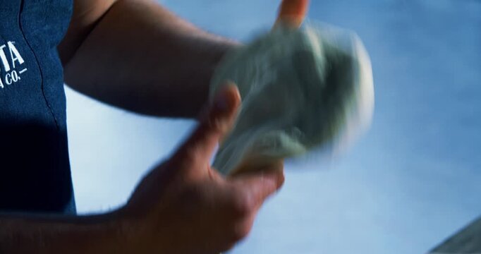 Panning, closeup shot from cooked corn on the cob to chef stretching out pizza dough
