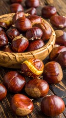A wooden bowl filled with chestnuts on a rustic table