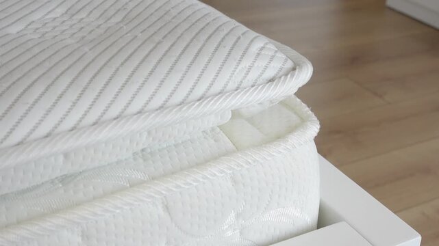 Close up video of white mattress and mattress topper, showing the details of the fabric and stitching, ideal for home comfort and bedding themes