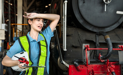 woman wearing a safety vest and holding a tablet is sweating
