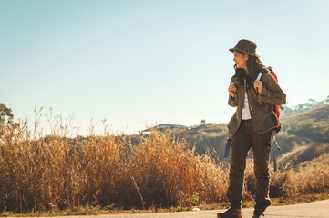 woman is walking in the wilderness with a backpack on her back