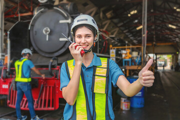 woman wearing a yellow vest and a hard hat is giving a thumbs up