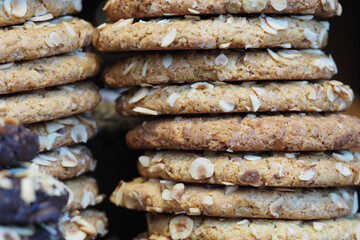 Oat cookies stacked on a shelf in a bakery display