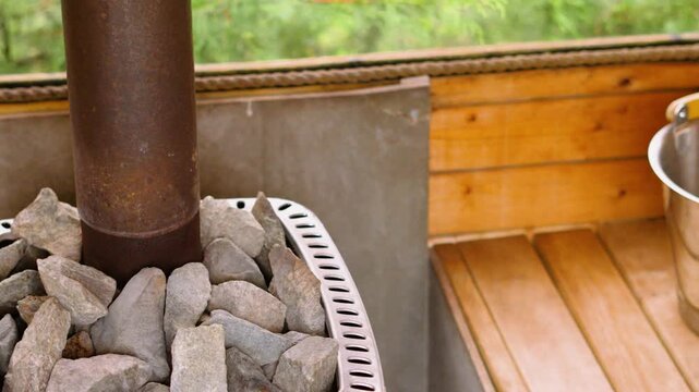 Rich oak wood of sauna with ladel with bucket of water ready for creating steam. Luxury spa treatments, self-care routines, stress reduction. Part of routine for health and longevity.