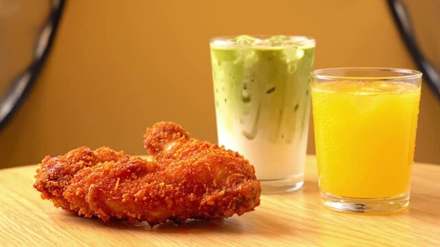 Crispy Fried Chicken Drumsticks with Matcha Iced Latte and Orange Juice. Golden, perfectly crispy fried chicken drumsticks with a thick, crunchy breadcrumb coating