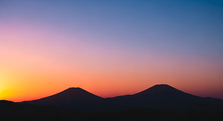 Obraz premium Silhouette of Mountains at Sunset.