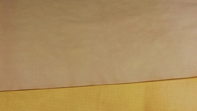 A close-up shot shows sheets of paper being placed one on top of another. This craft process creates a beautiful background of eco-friendly recycled material with unique organic patterns.