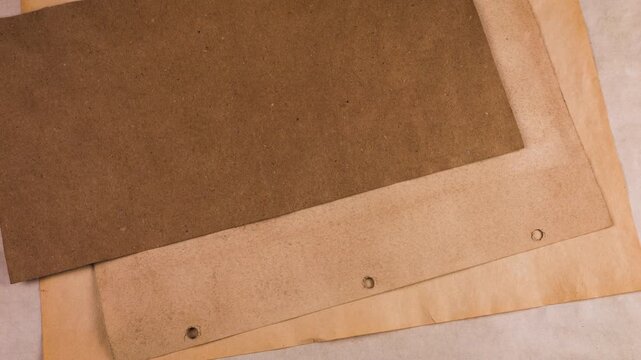 Handmade junk journal background with natural dyed old paper. Sheets of handmade, eco-friendly paper with natural coloring are stacked one by one, creating a grunge, vintage background texture.
