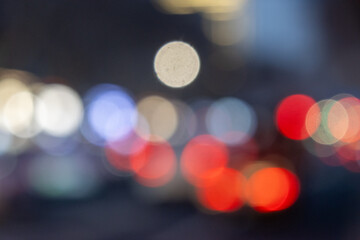 Abstract colorful bokeh lights background with red and white blurred circles of night city traffic...