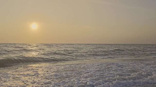 Golden Sunset Over the Sea Horizon and Waves on the Beach in Thailand.