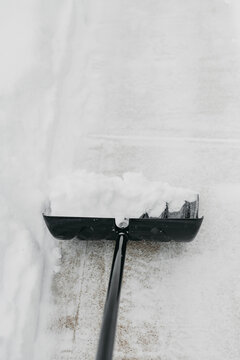 Shoveling the snow off of a sidewalk 