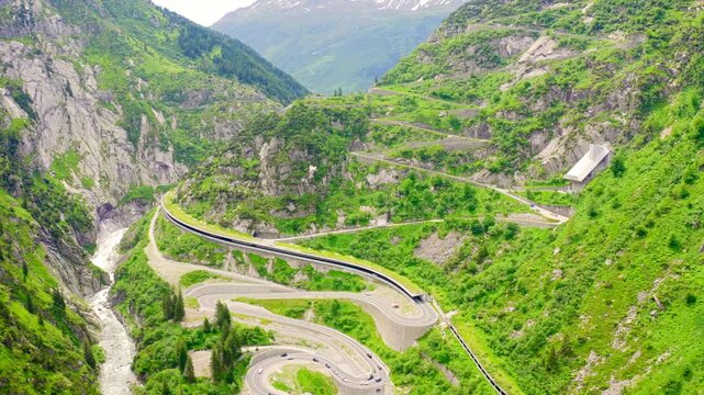 Switzerland. View from behind a mountainside on Andermatt. Picturesque winding mountain road with tunnels Gotthardstrasse. Drone footage