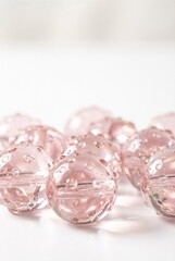 Pink Crystal Glass Marbles with Water Droplets on White Background