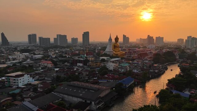 Golden buddha statue at wat paknam phasi charoen sunset sky with rivaer aerial view sightseeing travel in Bangkok Thailand 