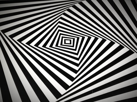 Abstract black and white geometric pattern featuring concentric angular lines forming a hypnotic spiral and optical illusion effect. High-contrast monochrome design with a dynamic perspective, suitabl