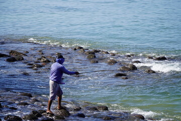 man fishing on the beach